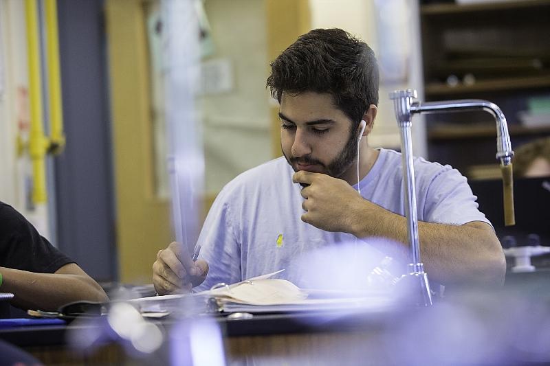 student reviewing science notes in science classroom