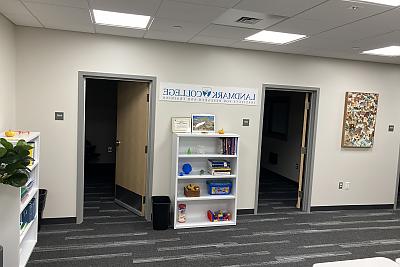 Office space with bookcase and sign labelled 